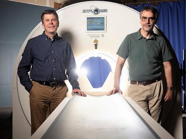 Project leaders Professors Simon Cherry and Ramsey Badawi next to the EXPLORER mock-up at UC Davis Health